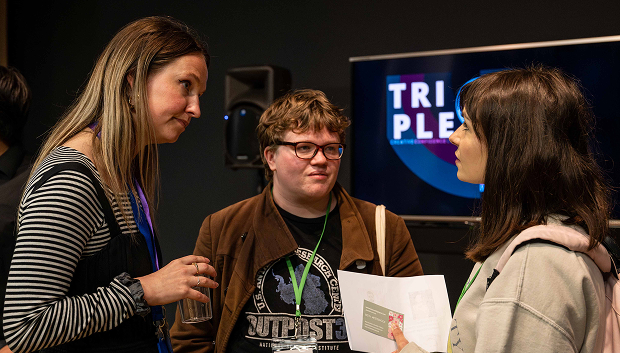 Three people in conversation at an event